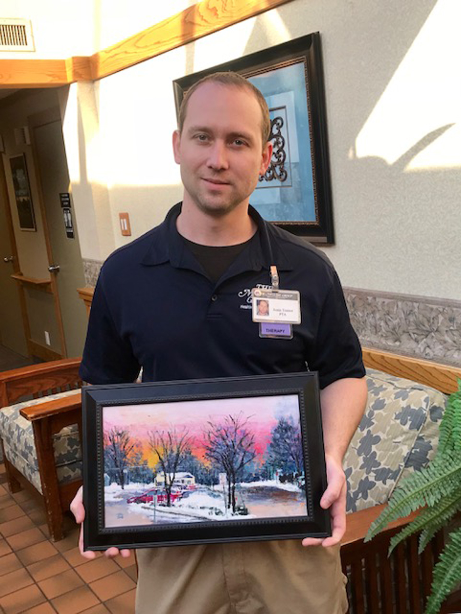 Justin Trainor is pictured holding a photo that depicts the scene as you pull out of Northgate's driveway.